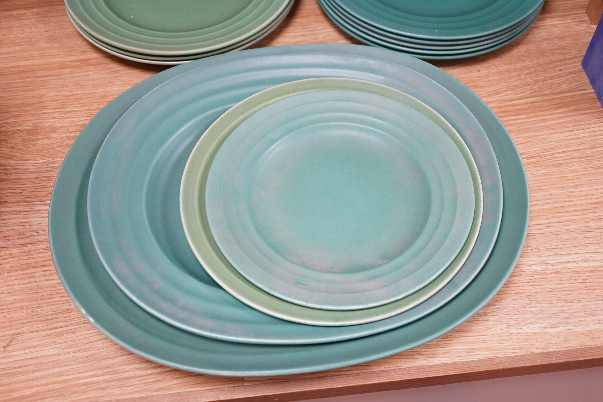 Keith Murray for Wedgwood, Annular part service comprising plates and two oval serving dishes, largest 38cm wide